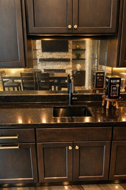 Antique mirror backsplash on a wet bar, lit from under the cabinets