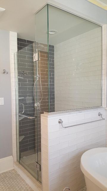 Frameless panel and door on a half wall