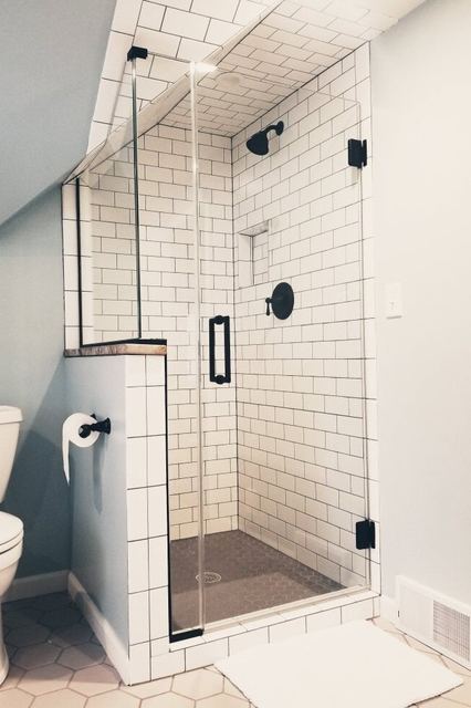 Frameless shower under a sloped ceiling