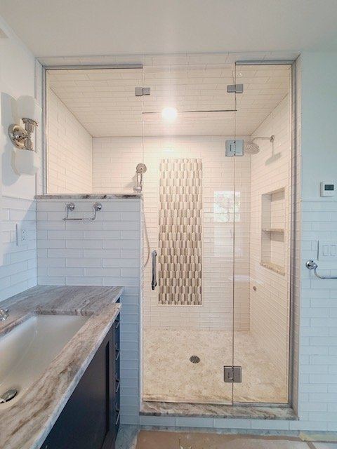 Frameless steam shower enclosure with a transom