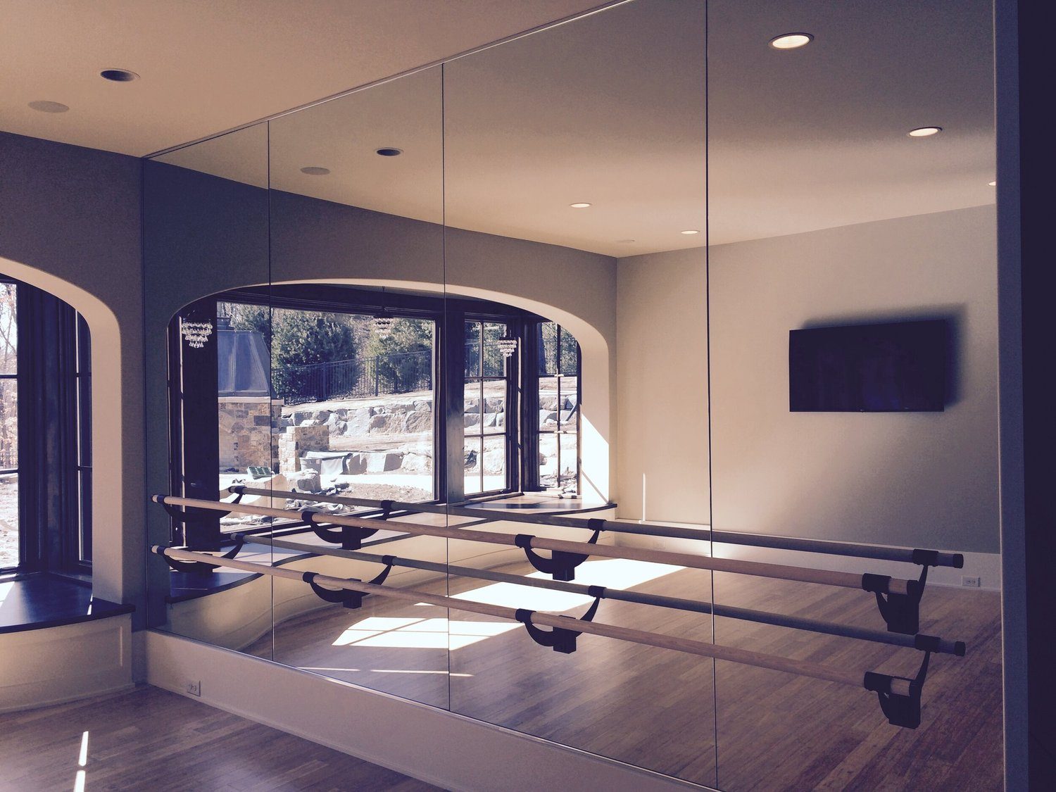 Wall-to-wall custom mirror in a fitness room