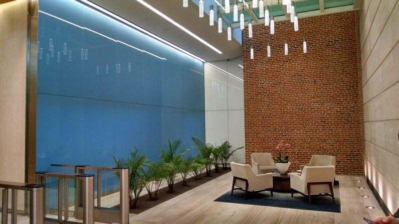 Full-height back-painted glass wall in a lobby