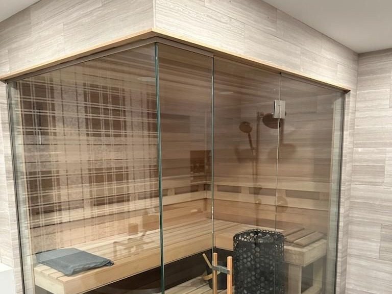 Glass-fronted cedar sauna enclosure