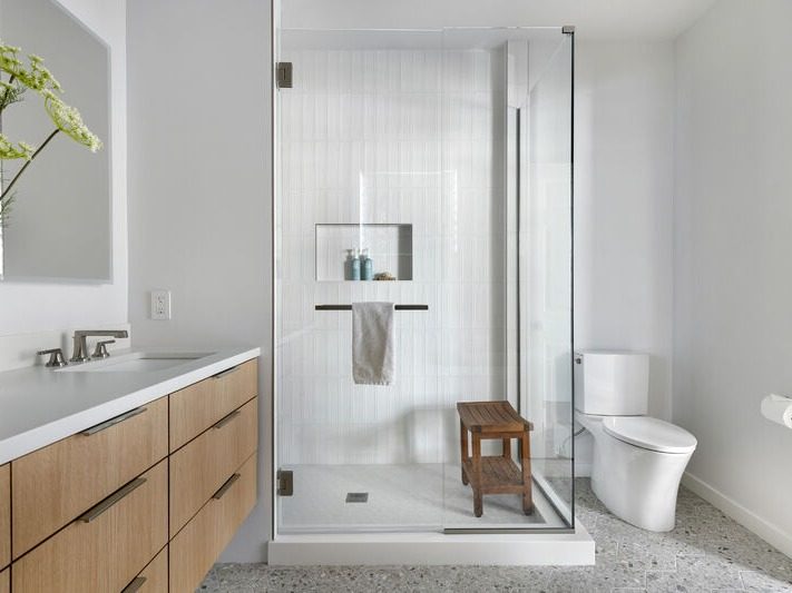 Frameless corner shower enclosure in a finished bathroom