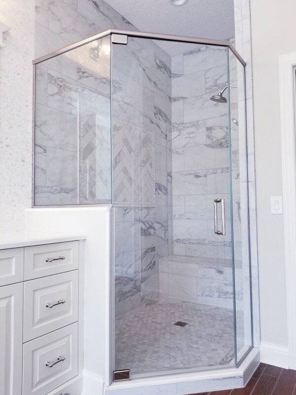 Frameless glass shower enclosure