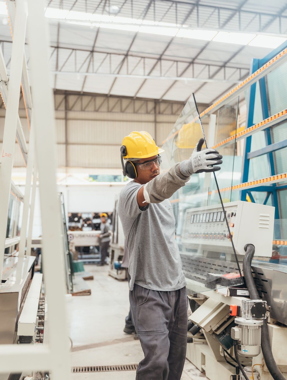 Fabricator handling a glass sheet on the shop floor
